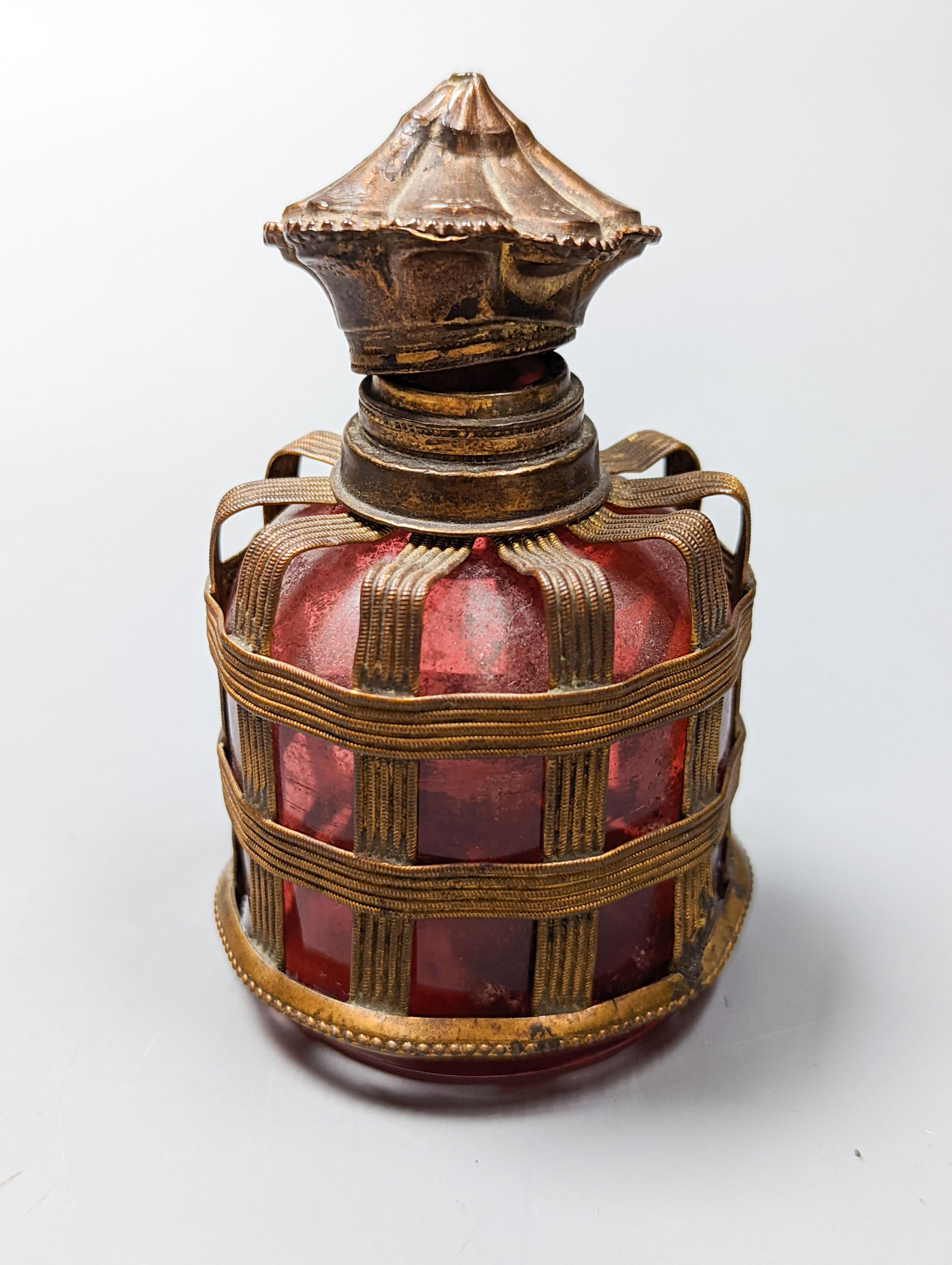 A cased Victorian engraved gilt white metal and coral set double ended scent bottle, 13.4cm, a silver cigar cutter, a belt, a silver buckle, gilt and cranberry perfume bottle, etc.